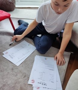A child working through a SATs in 6 practice paper at home